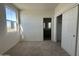 Bedroom with a window, closet, and neutral carpeting with ensuite bath access at 47219 W Pecan Woods --, Maricopa, AZ 85139