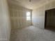 A bedroom features new drywall, a bright window view, and electrical outlets ready for customization at 47219 W Pecan Woods --, Maricopa, AZ 85139