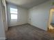 Bedroom with neutral carpet, a window, and a white door at 47219 W Pecan Woods --, Maricopa, AZ 85139