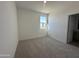 Neutral bedroom featuring a window, plush carpeting, and an ensuite bathroom at 47219 W Pecan Woods --, Maricopa, AZ 85139