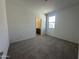 Bedroom featuring neutral carpeting, a window, and access to an ensuite bathroom at 47219 W Pecan Woods --, Maricopa, AZ 85139