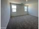 Neutral bedroom with carpet, two windows, and ample natural light at 47219 W Pecan Woods --, Maricopa, AZ 85139