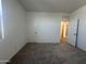 Bedroom with neutral carpeting, white walls, a window and white doors at 47219 W Pecan Woods --, Maricopa, AZ 85139