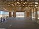 Unfinished interior showing exposed wood framing, concrete floor, and exterior view at 47219 W Pecan Woods --, Maricopa, AZ 85139