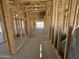 Interior view of new home construction with exposed wood framing and concrete slab at 47219 W Pecan Woods --, Maricopa, AZ 85139