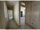 Open hallway view reveals smooth drywall, window light, and future access to multiple rooms at 47219 W Pecan Woods --, Maricopa, AZ 85139