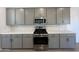Kitchen featuring stainless steel appliances and gray cabinets at 47219 W Pecan Woods --, Maricopa, AZ 85139