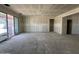Bright living room with sliding glass doors and unfinished drywall, creating a canvas for customization at 47219 W Pecan Woods --, Maricopa, AZ 85139