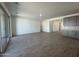 Spacious living room with tile floors, sliding glass door to patio, and modern gray cabinetry at 47219 W Pecan Woods --, Maricopa, AZ 85139