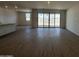 Open living room with tile floors and sliding glass doors at 47219 W Pecan Woods --, Maricopa, AZ 85139