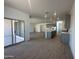 Open concept living space with modern kitchen, island, stainless appliances and gray cabinets at 47219 W Pecan Woods --, Maricopa, AZ 85139