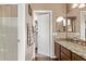 Well-lit bathroom with granite counters, walk-in shower, and open doorway to closet at 4757 E Goldfinch Gate Ln, Phoenix, AZ 85044