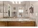Bathroom featuring dual sinks, granite countertops, and ample mirror space for convenience at 4757 E Goldfinch Gate Ln, Phoenix, AZ 85044