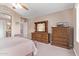 Bedroom with full wooden dresser and neutral tones and carpeting, creating a cozy atmosphere at 4757 E Goldfinch Gate Ln, Phoenix, AZ 85044