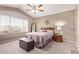 Comfortable bedroom featuring a ceiling fan, large window, and neutral carpeting for a relaxing ambiance at 4757 E Goldfinch Gate Ln, Phoenix, AZ 85044