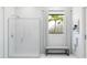 Modern bathroom featuring a glass shower, a bench, and a bright window at 491 E Aurora Dr, San Tan Valley, AZ 85140