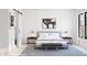 Serene bedroom featuring minimalist decor, soft lighting, and a stylish bench at 491 E Aurora Dr, San Tan Valley, AZ 85140