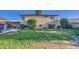 Expansive backyard featuring lush lawn, mature trees, and the exterior of the home, creating a serene outdoor space at 538 E Rockwood Dr, Phoenix, AZ 85024