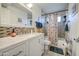 Well-lit bathroom featuring stylish mosaic tile backsplash, white vanity, and decorative accents at 538 E Rockwood Dr, Phoenix, AZ 85024