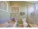 Bathroom featuring bathtub, shower, toilet, and starfish decorations at 538 E Rockwood Dr, Phoenix, AZ 85024