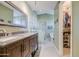 Bathroom features a double vanity, updated tile, and large walk-in closet at 538 E Rockwood Dr, Phoenix, AZ 85024