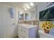 Bright bathroom featuring a vanity with a light countertop, mosaic backsplash, and framed mirror at 538 E Rockwood Dr, Phoenix, AZ 85024