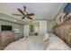 Beautiful bedroom featuring a ceiling fan, large bed, and storage at 538 E Rockwood Dr, Phoenix, AZ 85024