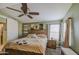 Comfortable bedroom with a ceiling fan and a large window at 538 E Rockwood Dr, Phoenix, AZ 85024