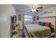 Well-lit bedroom features neutral paint, a ceiling fan, and bright window at 538 E Rockwood Dr, Phoenix, AZ 85024
