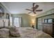 Comfortable bedroom featuring neutral paint, a ceiling fan, and cozy bedding at 538 E Rockwood Dr, Phoenix, AZ 85024