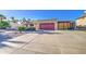 Long concrete driveway leading to a two-car garage and a private gated parking area at 538 E Rockwood Dr, Phoenix, AZ 85024