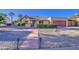 Charming single-story home features a well-manicured desert front yard, covered entry and two car garage at 538 E Rockwood Dr, Phoenix, AZ 85024