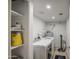 Efficient laundry room with modern washer, dryer, and organized shelving at 538 E Rockwood Dr, Phoenix, AZ 85024