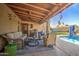 Covered outdoor patio with comfortable seating, ceiling fan, and view of the pool for relaxing and entertaining at 538 E Rockwood Dr, Phoenix, AZ 85024