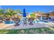Resort-style pool area with palm trees, rock waterfall, and comfortable seating for ultimate relaxation and entertainment at 538 E Rockwood Dr, Phoenix, AZ 85024