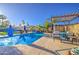 Stunning pool area with a wooden pergola, palm trees, and multiple seating areas, perfect for outdoor entertaining at 538 E Rockwood Dr, Phoenix, AZ 85024