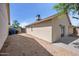 Side yard with desert landscaping, trash containers, and a gate to the front yard at 6335 E Brown Rd # 1065, Mesa, AZ 85205