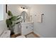 This is a lovely half bathroom with modern lighting and a white cabinet and countertop at 6335 E Brown Rd # 1065, Mesa, AZ 85205