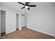An airy bedroom with hardwood floors, white walls, and a closet with sliding doors at 6335 E Brown Rd # 1065, Mesa, AZ 85205