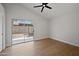 Bedroom with a ceiling fan, a view of the backyard through sliding glass doors, and wood floors at 6335 E Brown Rd # 1065, Mesa, AZ 85205