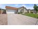 Exterior shot of a well-kept home with a long driveway and attached two car garage at 6335 E Brown Rd # 1065, Mesa, AZ 85205