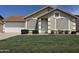 Charming single-story home with manicured lawn and white trimmed windows and door at 6335 E Brown Rd # 1065, Mesa, AZ 85205