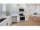 A modern kitchen is featured with white cabinets, stainless steel appliances and an eat-in dining area at 6335 E Brown Rd # 1065, Mesa, AZ 85205
