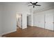 Primary bedroom with en-suite bathroom, ceiling fan, closet, and luxury vinyl plank flooring at 6335 E Brown Rd # 1065, Mesa, AZ 85205