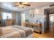 Serene bedroom features natural light, wood floors, and calming blue walls with stylish decor at 7001 E Flossmoor Ave, Mesa, AZ 85208