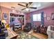 Cozy bedroom with purple walls, ceiling fan, and ample space, perfect for relaxation at 7001 E Flossmoor Ave, Mesa, AZ 85208