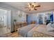 Relaxing bedroom with light blue walls, wood floors, and view of the bathroom at 7001 E Flossmoor Ave, Mesa, AZ 85208