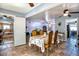 Well-lit dining area with travertine floors, a table set for four, and open access to other rooms at 7001 E Flossmoor Ave, Mesa, AZ 85208