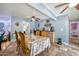 Dining area featuring travertine floors, a table set for four, and open access to other rooms at 7001 E Flossmoor Ave, Mesa, AZ 85208