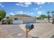 Charming single-story home featuring an expansive driveway with beautiful desert landscaping at 7001 E Flossmoor Ave, Mesa, AZ 85208
